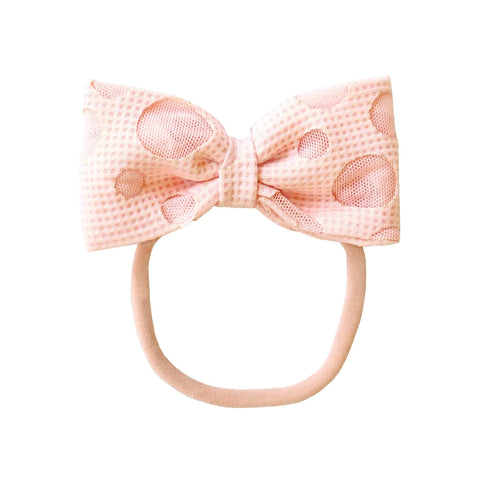 Alli.C, pink bow that newborn baby girl’s or toddlers can wear as a headband or ponytail holder. The Gwendolyn Bow is 4 inches with white mesh circles.