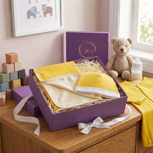 Baby gift set with yellow baby blanket with white dots & matching baby hat with silk lining in an Alli.C signature purple box.