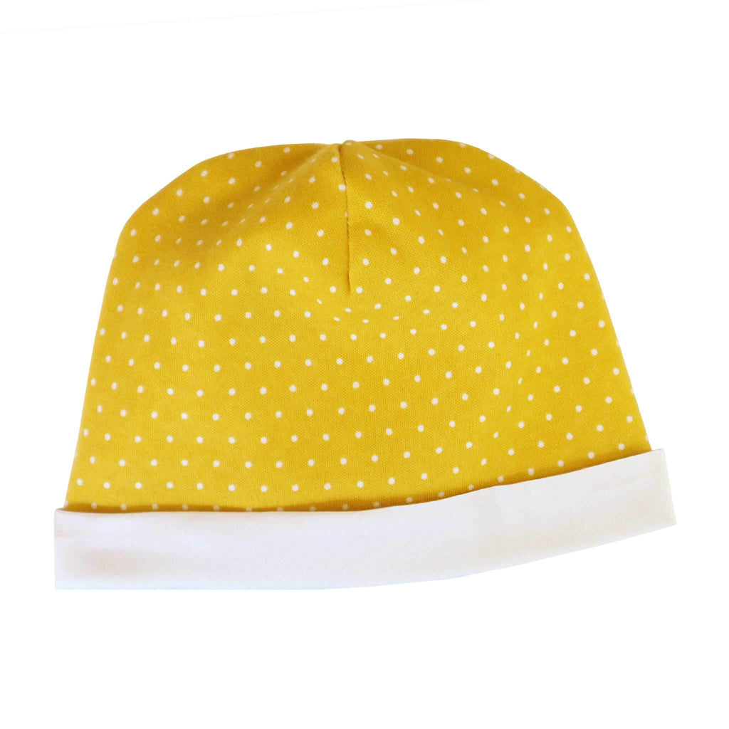 Alli.C, gender neutral yellow baby hat with white polka dots, and white silk lining.